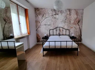 Letto o letti in una camera di B&B Via Guareschi