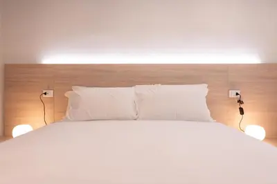 Letto o letti in una camera di Fortitudo Appartamento Duomo Cremona Self Check-in Centro Storico