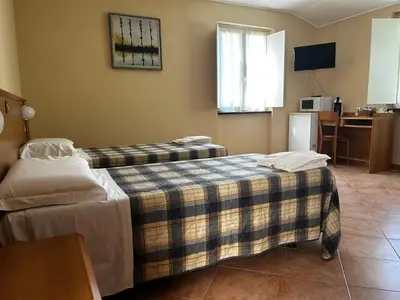 Letto o letti in una camera di INOSTERIA Affittacamere
