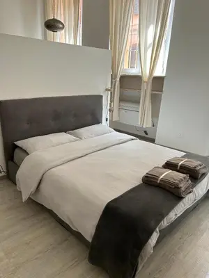 Letto o letti in una camera di Splendido Loft Centro Storico Parma