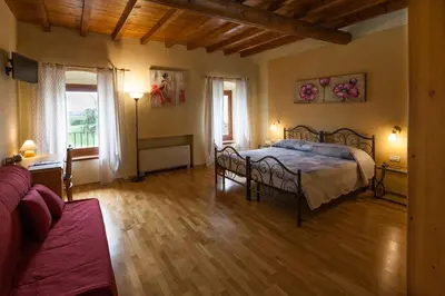 Letto o letti in una camera di Hotel Alla Corte dei Bicchi