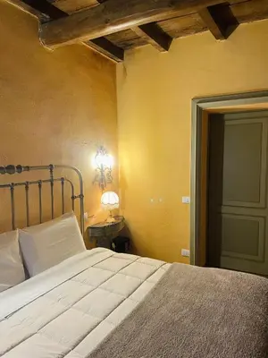 Letto o letti in una camera di BORGO VILLA VALENTINI