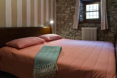 Letto o letti in una camera di Charming & Authentic Stone House La Brugna