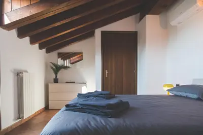 Letto o letti in una camera di Castelletto - Armonia rustica e moderna