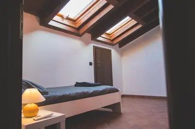 Letto o letti in una camera di Castelletto - Armonia rustica e moderna