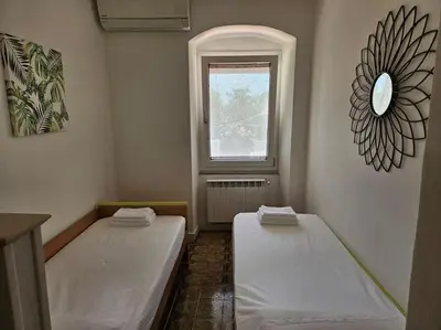 Letto o letti in una camera di Casa Arcobaleno - giardino e parcheggio gratuito