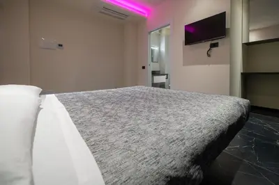 Letto o letti in una camera di Punto Zero Lux il primo boutique concept a Reggio Emilia