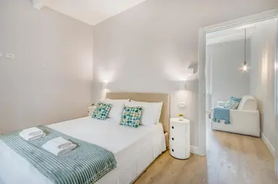 Letto o letti in una camera di ViaEmilia 2 min dal centro, 4 Persone, WIFI, Aria condizionata