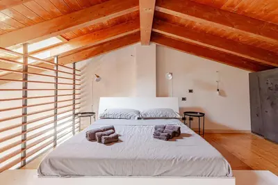 Letto o letti in una camera di Piacenza Open Space