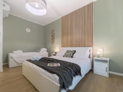 Letto o letti in una camera di Motor Valley Boutique Apartment - 3 Suites