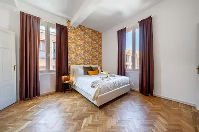 Letto o letti in una camera di Lussuoso appartamento con vista Ghirlandina
