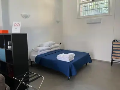 Letto o letti in una camera di Mini loft Rina - Stazione La Spezia Migliarina