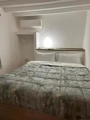 Letto o letti in una camera di Les Suites di Parma - Cavour
