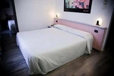 Letto o letti in una camera di Ilga Hotel