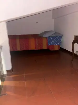 Letto o letti in una camera di appartamento CERRETO LAGHI