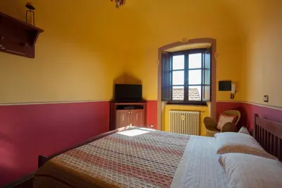 Letto o letti in una camera di B&B La Pulce Dorata