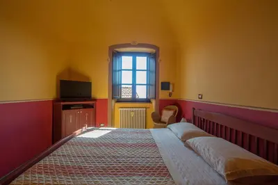 Letto o letti in una camera di B&B La Pulce Dorata