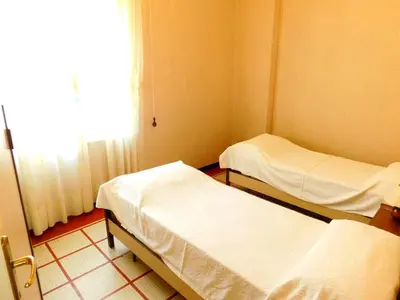 Letto o letti in una camera di Vicino alla spiaggia