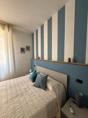 Letto o letti in una camera di Rooms primo piano