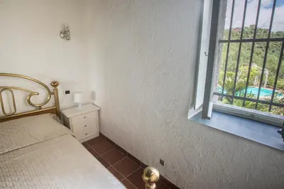 Letto o letti in una camera di 277B - Il Frantoio della Marchesa - Giardino e Piscina nel verde di Sestri Levante