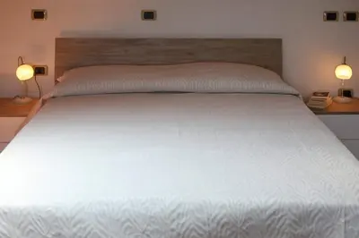 Letto o letti in una camera di Villa Paola - mansarda Glam -