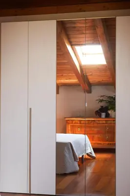 Letto o letti in una camera di Villa Paola - mansarda Glam -