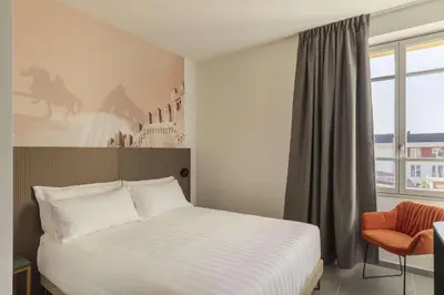 Letto o letti in una camera di B&B HOTEL Piacenza
