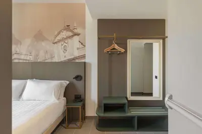 Letto o letti in una camera di B&B HOTEL Piacenza