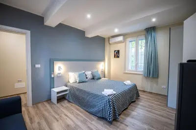 Letto o letti in una camera di La Chimera Appartamenti