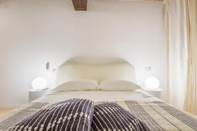 Letto o letti in una camera di Pietra di Piazza Grande - Rua Frati 34 Palace by MoVeBNB