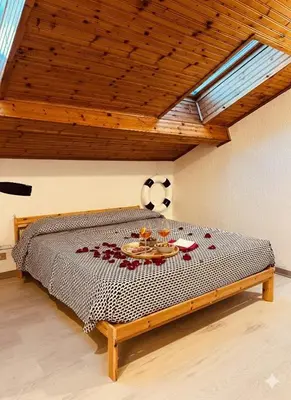 Letto o letti in una camera di LA MANSARDINA 