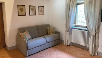 Area soggiorno di Le Stanze- apt for up to 4 pax with shared pool