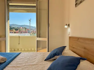 Letto o letti in una camera di Relax and Comfort con balcone, Lavagna