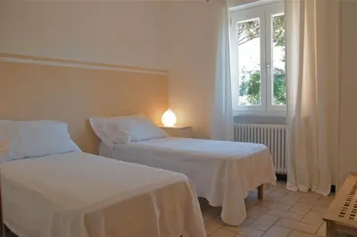 Letto o letti in una camera di Appartamento con giardino Dolcemare
