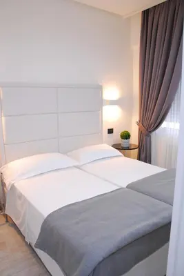 Letto o letti in una camera di LHP Suite Rapallo