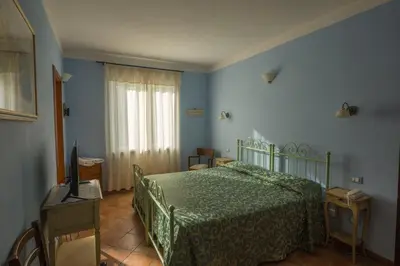 Letto o letti in una camera di Albergo Il Sicomoro