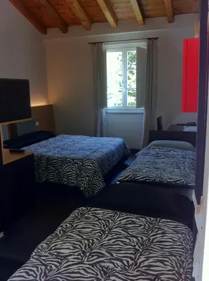 Letto o letti in una camera di Hotel Abetaia