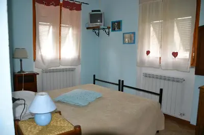 Letto o letti in una camera di Agriturismo LA TAVERNA DEL NONNO