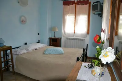 Letto o letti in una camera di Agriturismo LA TAVERNA DEL NONNO