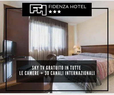 Letto o letti in una camera di Hotel Fidenza