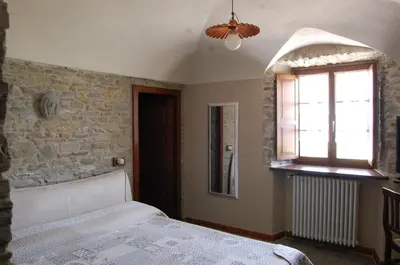 Letto o letti in una camera di Appartamenti Cenni - Relais su Lago