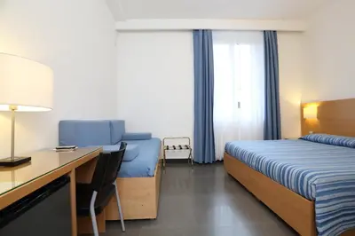 Letto o letti in una camera di Hotel Genova