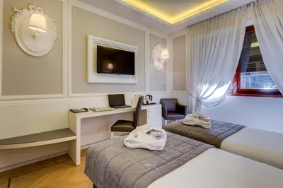 Letto o letti in una camera di Grande Albergo Roma