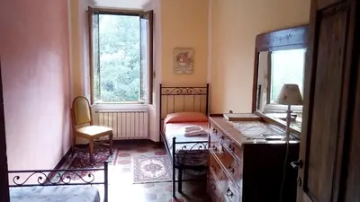 Letto o letti in una camera di Ca Giulietto Antico Casale in Lunigiana