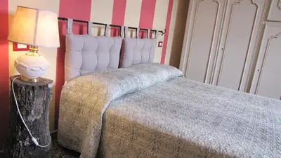 Letto o letti in una camera di Ca Giulietto Antico Casale in Lunigiana