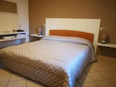 Letto o letti in una camera di B&B Covidafranciacorta