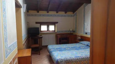 Letto o letti in una camera di Albergo Giulia Gonzaga