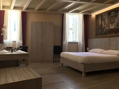 Letto o letti in una camera di Palazzo Domanto Apartments Parma