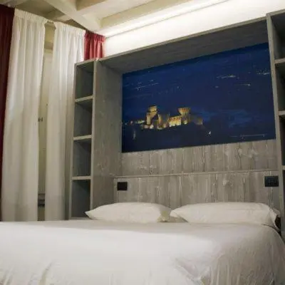 Letto o letti in una camera di Palazzo Domanto Apartments Parma