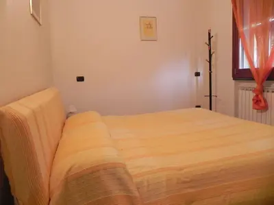 Letto o letti in una camera di azienda agricola zulin casa elena
